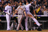DENVER, CO:  Carlos Gonzalez #5 of the Colorado Rockies scores on a wild pitch as pitcher Tim Lincecum #55 of the San Francisco Giants to give the Rockies a 5-0 lead in the third inning at Coors Field in Denver, Colorado.  (Photo by Doug Pensinger/Getty Images)