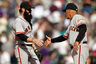 DENVER, CO -  Brian Wilson #38 of the San Francisco Giants shakes hands with third base coach Tim Flannery of the San Francisco Giants after defeating the Colorado Rockies 4-2 at Coors Field.  (Photo by Justin Edmonds/Getty Images)