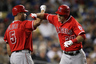LOS ANGELES, CA:  Mike Trout #27 of the Los Angeles Angels of Anaheim celebrates with Albert Pujols #5 after hitting a solo home run in the fourth inning against the Los Angeles Dodgers at Dodger Stadium in Los Angeles, California.  (Photo by Stephen Dunn/Getty Images)