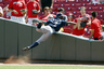 Nyjer Morgan of the Milwaukee Brewers reaches into the seats to battle for a foul ball with a fan during a game against the Cincinnati Reds at Great American Ball Park in Cincinnati, Ohio. The Brewers won 8-4. (Photo by Joe Robbins/Getty Images)