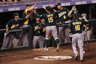 DENVER, CO - The Oakland Athletics celebrate as Seth Smith #15 of the Oakland Athletics and Josh Reddick #16 of the Oakland Athletics scored on the game winning two RBI double by Brandon Inge #7 of the Oakland Athletics in the ninth inning against the Colorado Rockies during Interleague Play at Coors Field  (Photo by Doug Pensinger/Getty Images)