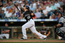 DENVER, CO:  Marco Scutaro of the Colorado Rockies drops his bat after hitting a fly ball in the eighth inning of a game against the San Diego Padres at Coors Field in Denver, Colorado.  (Photo by Dustin Bradford/Getty Images)