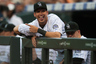 DENVER, CO: Tyler Colvin #21 of the Colorado Rockies has a laugh after Reds pitcher Johnny Cueto #47 of the Cincinnati Reds (not pictured) made an error on a pickoff attempt in the first inning of a game at Coors Field in Denver, Colorado. (Photo by Dustin Bradford/Getty Images)