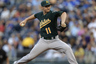 KANSAS CITY, MO:  Jarrod Parker #11 of the Oakland Athletics pitches against the Kansas City Royals in the second inning at Kauffman Stadium in Kansas City, Missouri. (Photo by Ed Zurga/Getty Images)