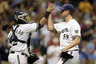 John Axford of the Milwaukee Brewers celebrates with Martin Maldonado after the 6-3 win over the Cincinnati Reds at Miller Park in Milwaukee, Wisconsin. (Photo by Mike McGinnis/Getty Images)