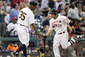 Jose Altuve of the Houston Astros receives congratulations from third base coach Dave Clark after hitting a three-run home run against the St. Louis Cardinals at Minute Maid Park in Houston, Texas.   (Photo by Bob Levey/Getty Images)